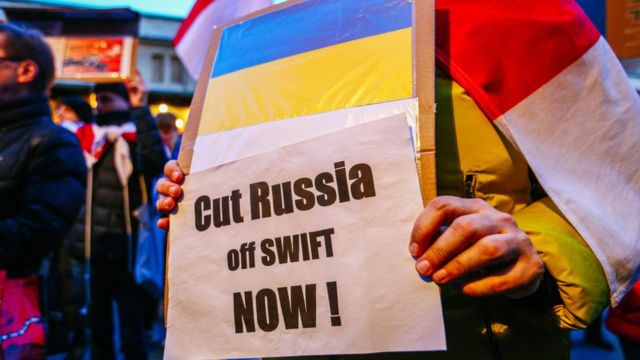 People protesting and calling for Russia to be excluded from the Swift network.