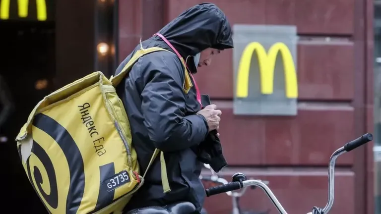 A delivery man waits outside a McDonald's in Russia