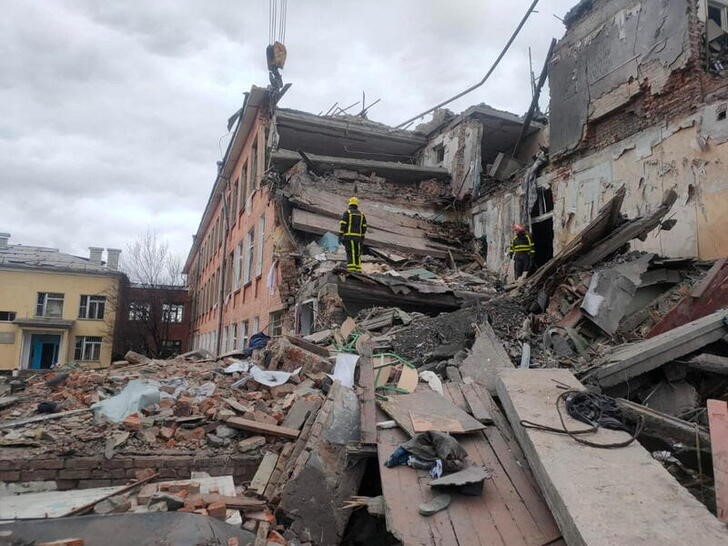 Monday photo of rescuers removing the rubble of a Russian bombed school in Chernigov on March 7, 2022. Press service of the Ukrainian State Emergency Service / Posted via Reuters