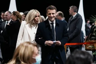 France's president and LREM presidential candidate, Emmanuel Macron, and his wife Brigitte Macron wait before voting in the first round of the presidential election.