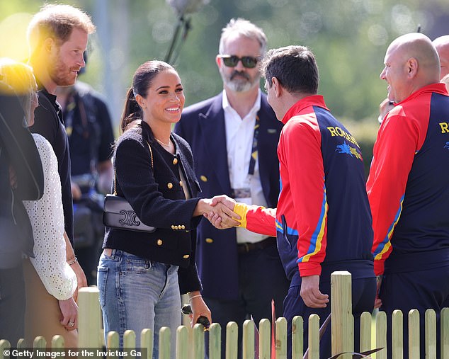 Megan shook hands with a member of the Romanian team on the first day of the Invictus Games