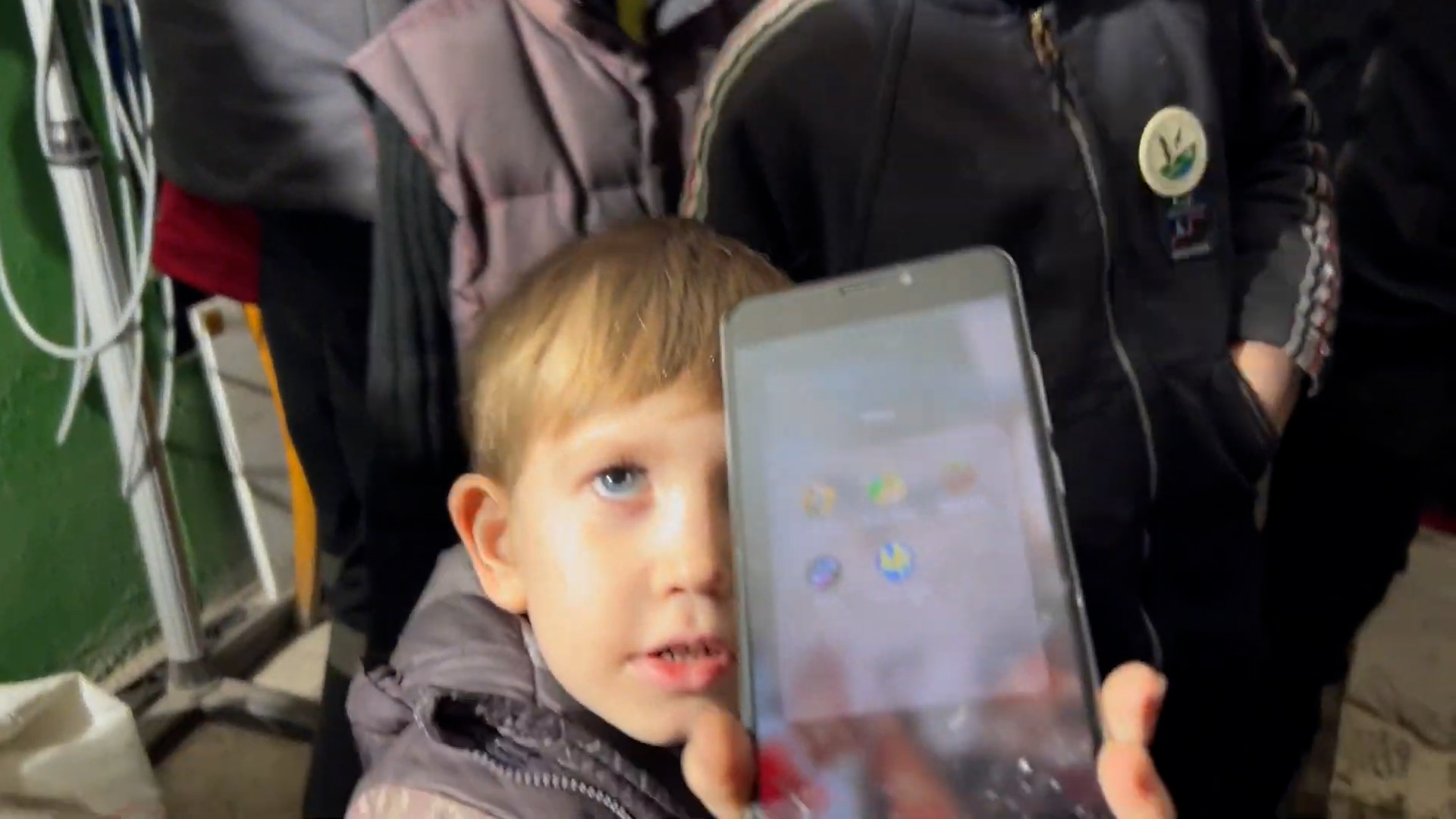 boy showing cell phone screen
