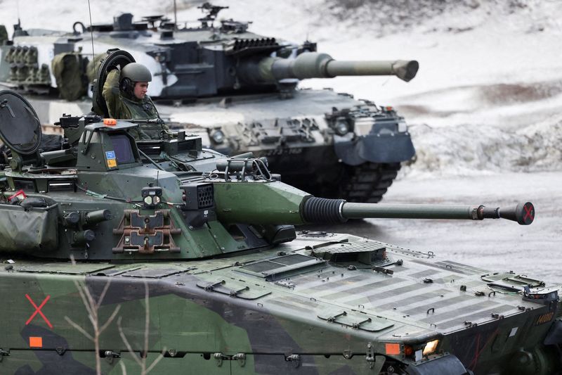 FILE PHOTO: Swedish and Finnish tanks during a military exercise called "Cold response 2022"About 30,000 soldiers from NATO member states plus Finland and Sweden, gathered during the Russian invasion of Ukraine, in Evens, Norway, March 22, 2022. REUTERS/Yves Hermann
