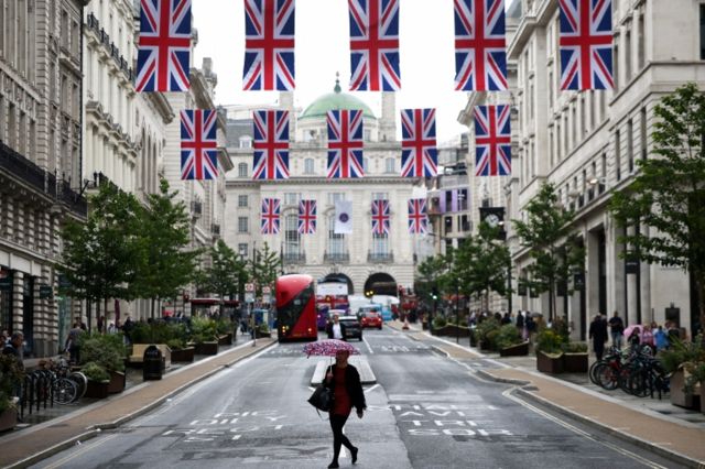 The streets of London are decorated with British flags.
