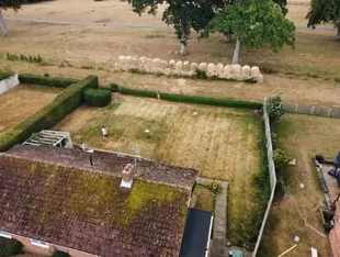 A dispute arose between neighbors over the construction of a hay wall in front of their garden.