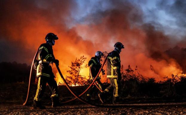 Firefighters work to put out fires in southwestern France. 