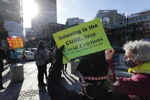 FILE - In this Jan. 13, 2021 photo, protesters protest against evictions outside the courthouse in Boston.  The Joe Biden administration is taking action to prevent evictions from public housing for non-payment of rent.  (AP Photo/Michael Dwyer, file)