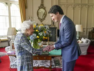 Britain's Queen Elizabeth II welcomes Canadian Prime Minister Justin Trudeau during a meeting at Windsor Castle, England, Monday, March 7, 2022 (Steve Parsons/Pool via AP)