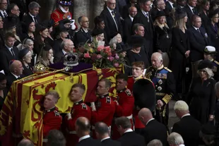 Download the coffin of Queen Elizabeth II as it follows King Charles III and Queen Camilla after her funeral at Westminster Abbey (Phil Noble/Pool Photo via AP)
