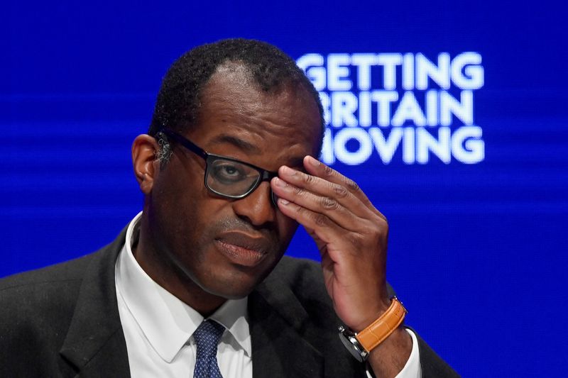 British Chancellor of the Exchequer Kwasi Quarting adjusts his glasses during the annual British Conservative Party conference in Birmingham, Britain, October 3, 2022. REUTERS/Toby Melville/File