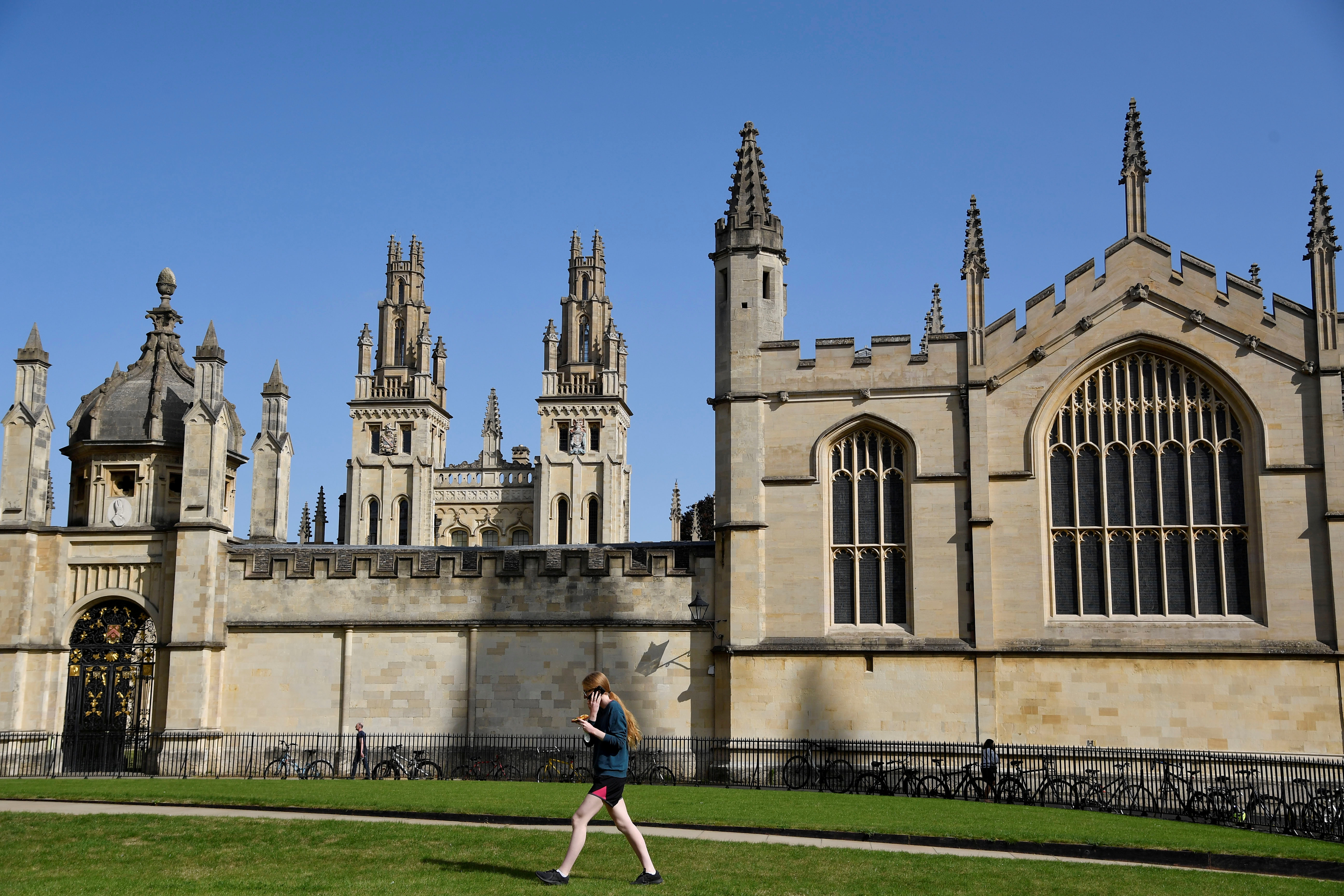 A student walks through a garden outside All Souls College at the University of Oxford, before the new school year (REUTERS/Toby Melville/File photo)