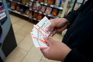 James Franklin, of Baltimore, holds Powerball lottery tickets he bought at a grocery store, Wednesday, November 2, 2022, in Cockeysville, Maryland.  (Associated Press/Julio Cortez)